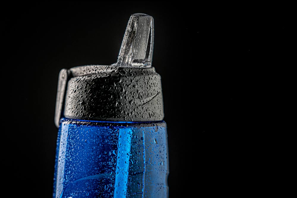 Nike blue water bottle with condensation product catalog photography